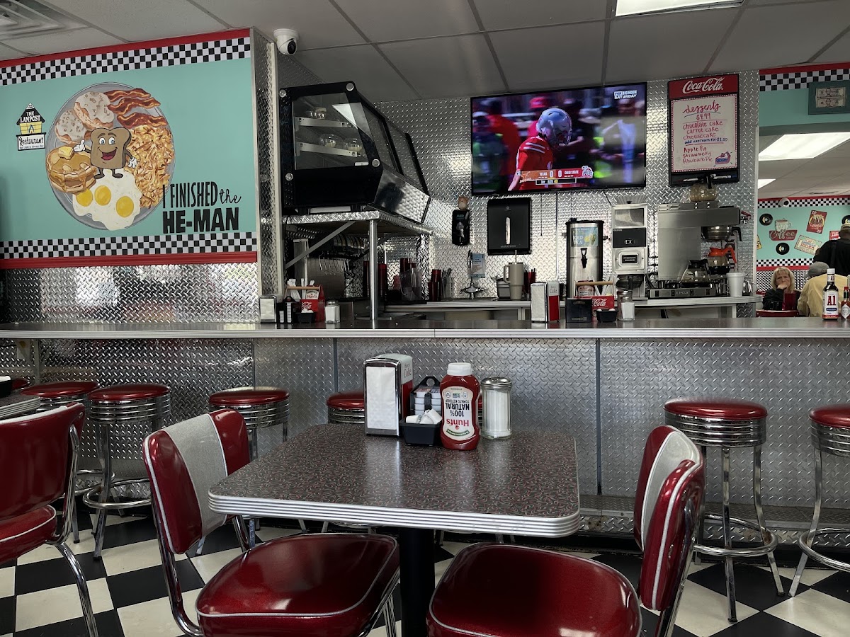 Retro diner interior with red vinyl booths and checkered floors at The Lampost